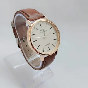 Minimalist quartz watch with gold-tone case and brown leather strap on white background