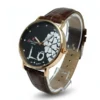 Black dial leather strap watch for women with gold case and heart design
